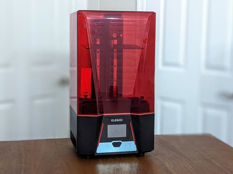 The Elegoo Saturn 2 on a table with doors behind it